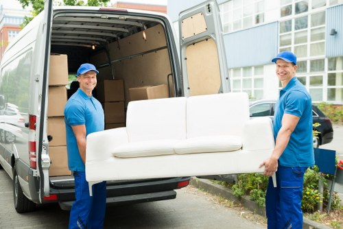 Moving van loading safely with protective covers and careful handling