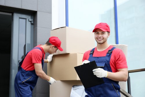 Mover wearing PPE while lifting furniture safely