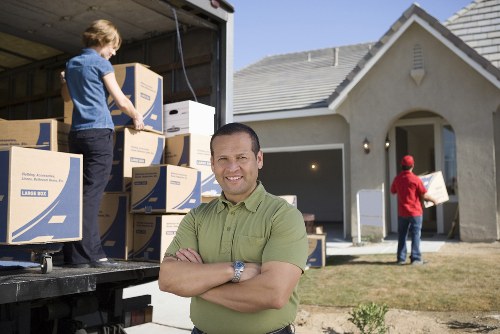 Professional movers loading furniture into a van in Collierswood
